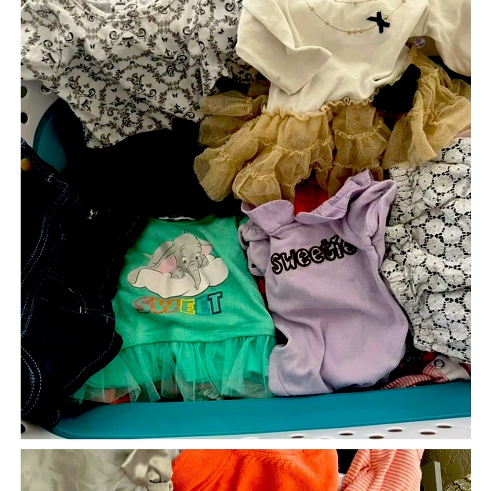 bundle of baby clothes and swaddles